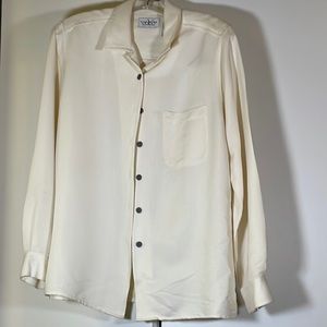 This is a dressy cream colored top that adds flare to any dress, skirt, or pants